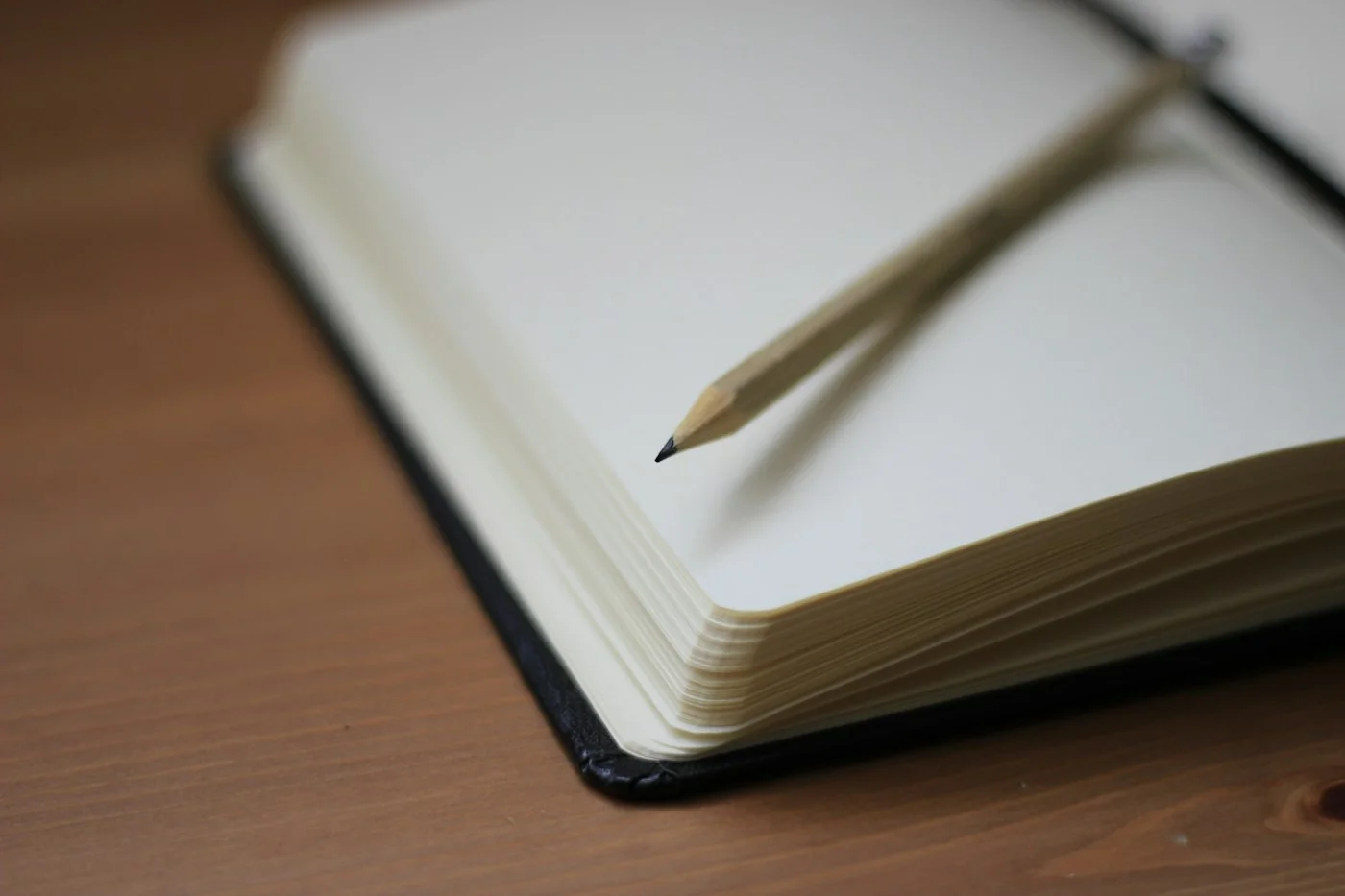 A pencil on an open notebook