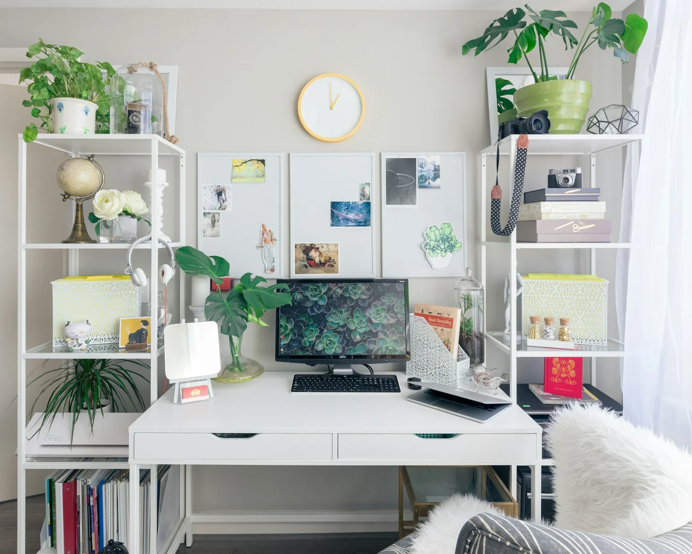 A bright creative workspace with a computer and books